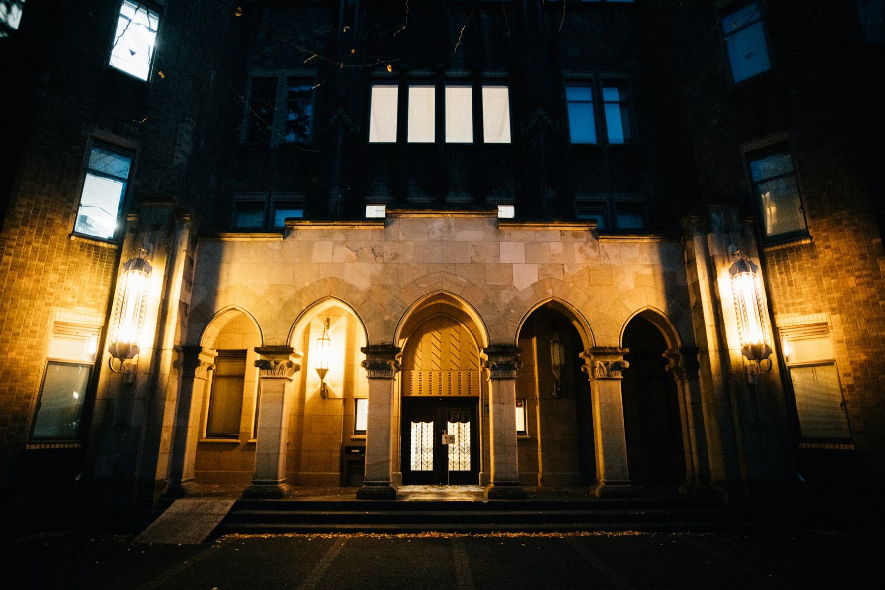 Classic stone estate entrance lit at night