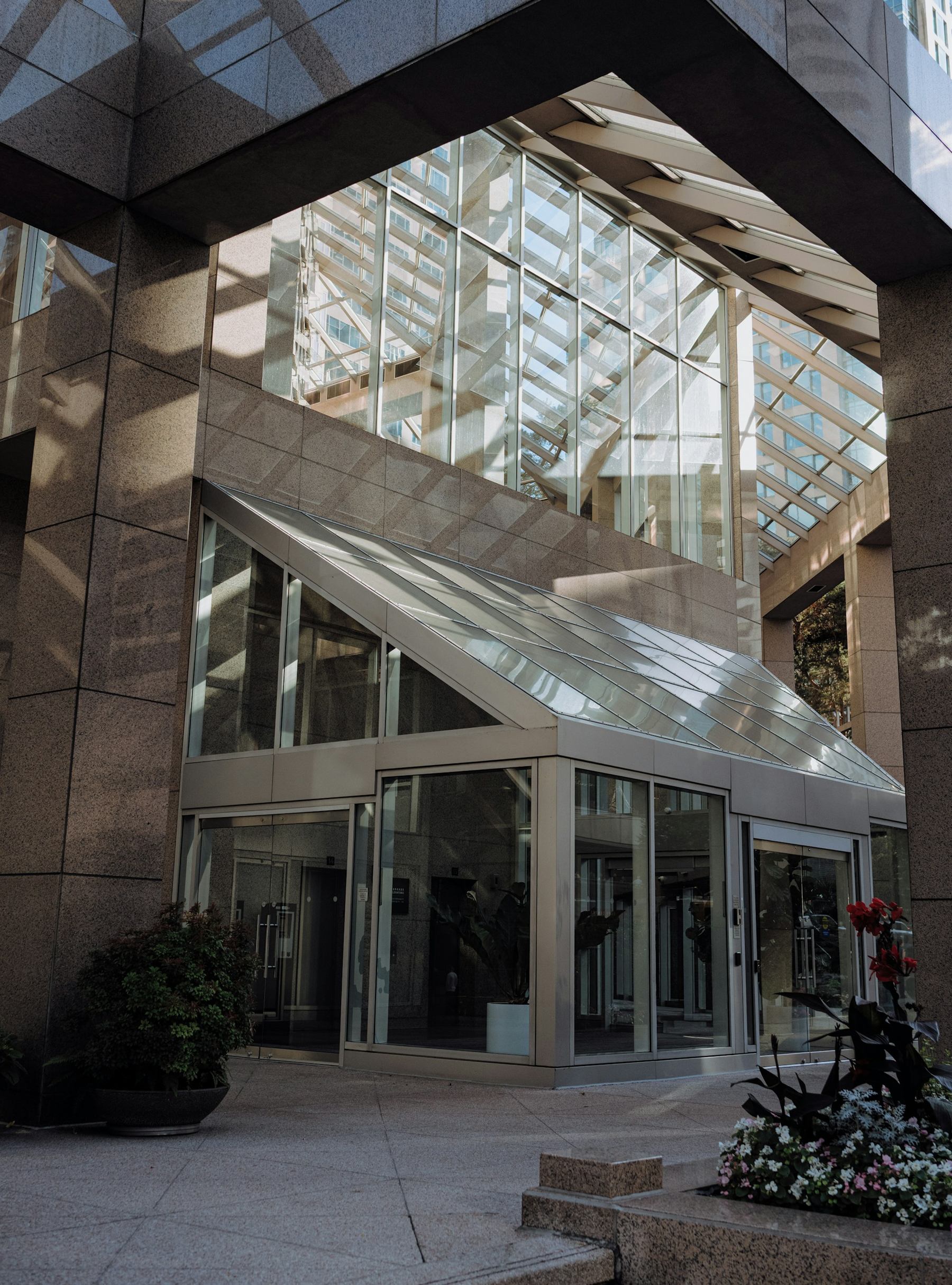 Office building entrance with glass doors and atrium glazing